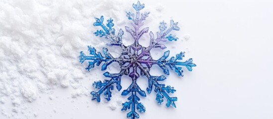 Christmas and New Year symbol: blue and purple snowflake alone on white background with natural snow.