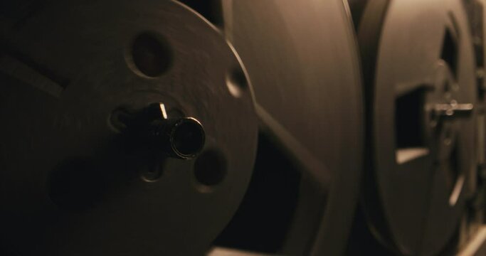 The vintage recorder spools are spinning fast in a blinking light