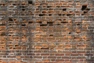 Background from an old brick wall with bricks falling out in some places