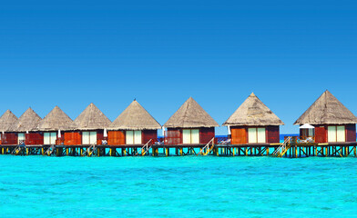 Water villas stand abreast in Maldivian sea 6