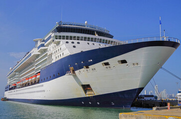 Cruiseship cruise ship liner Infinity in port with harbor infrastructure moored to pier