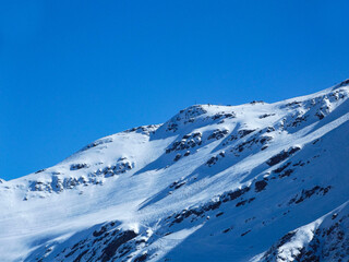 Fototapeta na wymiar Winter mountains, white snow-capped mountain peak. Mountains of the North Caucasus.