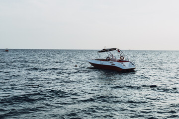 Fototapeta na wymiar boat anchored in the sea. Mediterranean Sea. coastline and rescue boat