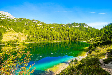 Steirersee on the high plateau of the Tauplitzalm. View of the lake at the Toten Gebirge in Styria. Idyllic landscape with mountains and a lake on the Tauplitz in Austria.
