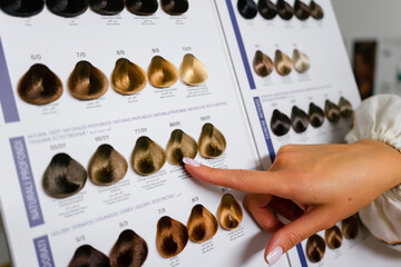 View of Woman Choosing Color from the Hair Color Chart For Hair Dye Concept