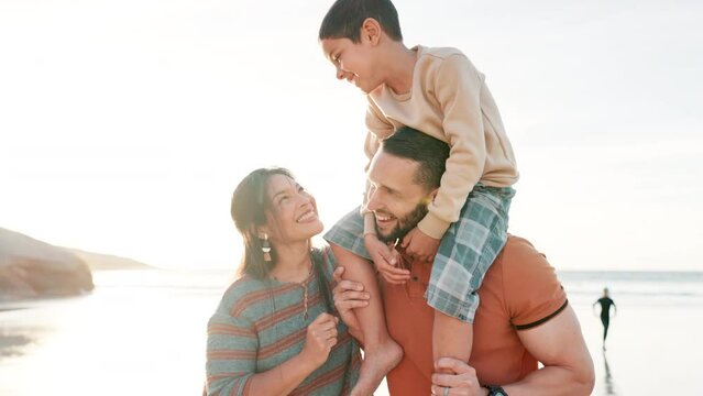 Beach, parents and child on shoulders of father for adventure, playing or bonding together. Happy, sunset and boy kid with young mom and dad by ocean on tropical vacation, holiday or weekend trip.