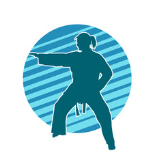 Silhouette of a slim female doing martial art pose. Silhouette of a martial art woman in action pose.