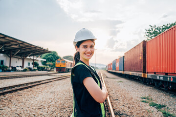 Portrait of woman engineer railway standing and looking camera in train factory. Maintenance cycle concept.