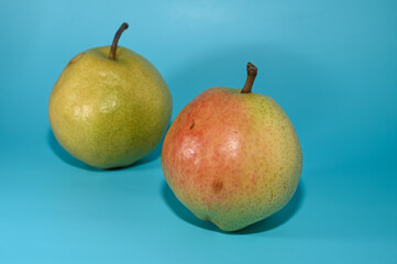 two juicy pears on a green background studio shooting 1