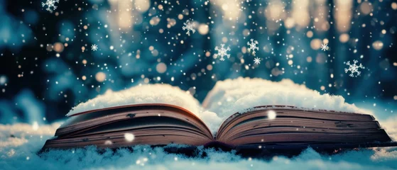 Foto auf Acrylglas A open book with a snowy landscape on its pages, tiny snowflakes drift out into the real world. Christmas fairy-tale. Winter holiday with bokeh © Gasi