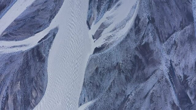Aerial view of glacier river branches from above, Icelandic glacial river bed and moraine by drone. Climate change and global warming