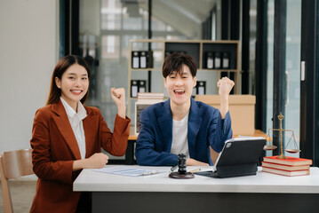 Asian business team and lawyers discussing contract papers sitting at the table. Concepts of law, advice, legal services. at office