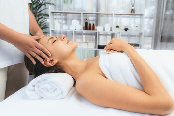 Caucasian woman enjoying relaxing anti-stress head massage and pampering facial beauty skin...