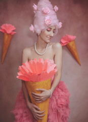 Fashion shot of beautiful young woman in pink dress with ice cream cone. Sweet lady cosplay.