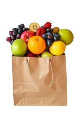Fresh assorted fruits in a brown paper bag on a light background, zero waste concept