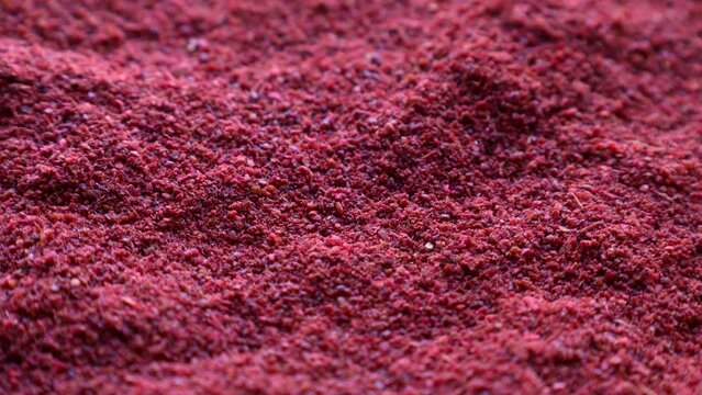 Red sumac spice powder circle rotation close up