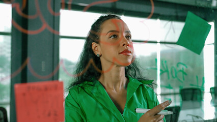 Young hispanic employee writing on colorful sticky notes. Smart businesswoman sharing marketing idea, brainstorming strategy, business plan. Project manager drawing mind map. Closeup. Manipulator.