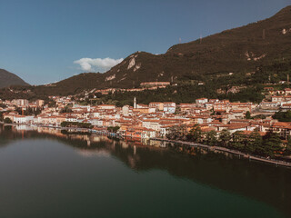 Fototapeta na wymiar Aerial drone view of Lovere, a small Italian town located on the shores of Lake Iseo in Lombardy. The day is sunny and clear during a summer morning