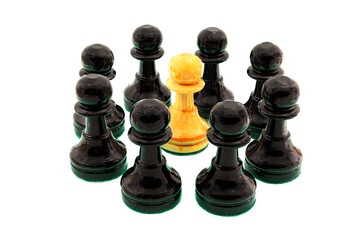 Black chess pawns surrounding a single white pawn.