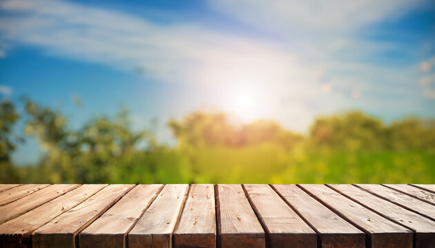 wood board table in front of summer landscape with lens flare. picture for background purpose