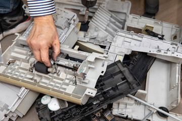 Plastic housings and parts of the disassembled printer. Computer junk.