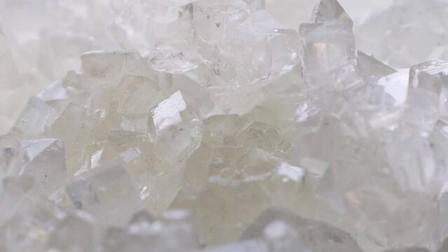 White rock candy sugar crystals or Dhaga Mishri (Crystal Sweet Candy, Patika Bellam, Khadi Sakar, Kuja Misri) circle rotation close up