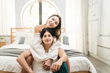 Obraz premium Portrait of a caucasian couple loving at home or hotel room together laughing and having fun. Happiness and joyful expression man and a woman celebrating Valentine's Day.