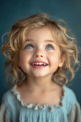 A close-up portrait of a little girl .She is a pretty, sweet, attractive, curious, creative, cheerful girl