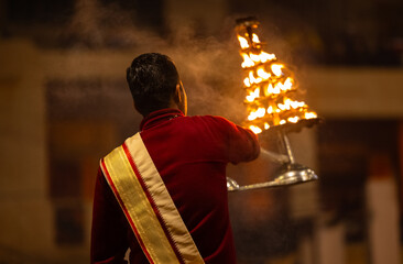 Ganga aarti, Portrait of young priest performing holy river ganges evening aarti at dashashwamedh...