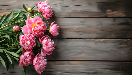 pink peonies on wooden table background top view