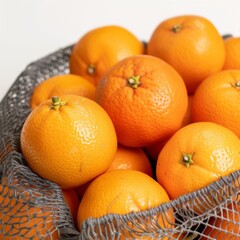 Bright oranges in a net bag with a close-up view on a white background, zero waste concept