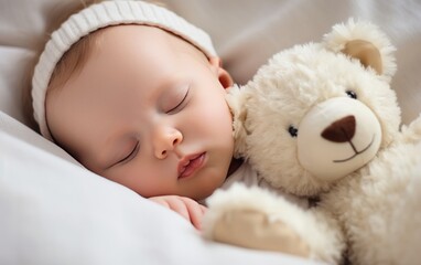 Carefree sleep little baby with a soft toy on the bed.