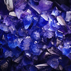 Tanzanites and raw crystal gems concept with closeup of a bunch of blue and purple uncut tanzanite or sapphire crystals