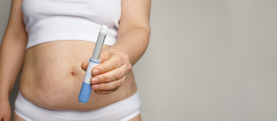 Semaglutide and weight loss concept. Woman showing Semaglutide Injection pen or insulin cartridge...