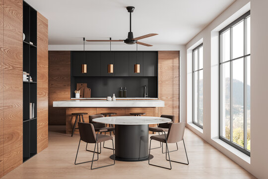 Stylish home kitchen interior with bar island and eating table with window