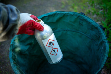 Chemically dangerous substances.A gloved hand holds a bottle of poisonous liquid.Disposal of toxic...