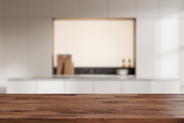 White kitchen with dark wooden product display desk