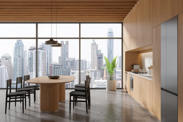 Wooden home kitchen interior with cooking and eating table, panoramic window