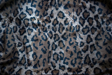 Photo of leopard cloth. The background of the leopard coloring texture.The clothes of the first people.