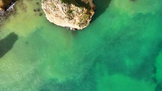 The beautiful Praia do Camilo with its golden sandstone cliffs located in Lagos on the Algarve region of southern Portugal.