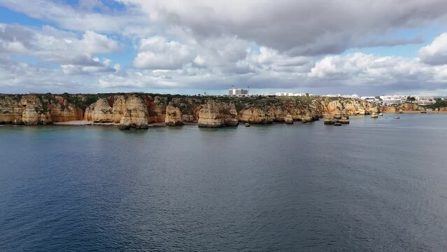 The beautiful Praia do Camilo with its golden sandstone cliffs located in Lagos on the Algarve region of southern Portugal.