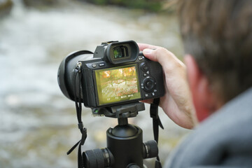 Photographer at work holding a digital camera