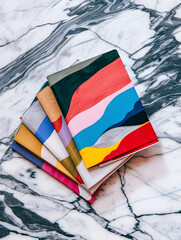 Artistic Flair: Colorful Abstract Notebooks on Marble
