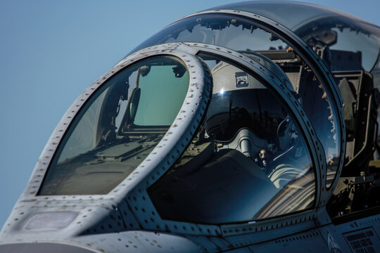 Close up view of the cockpit of a military fighter jet airplane.
