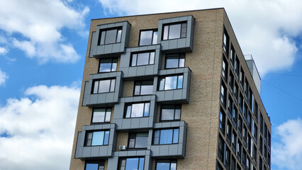 The end of the facade with square balconies against the sky