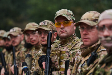 Soldier fighters standing together with guns. Group portrait of US army elite members, private military company servicemen, anti terrorist squad - obrazy, fototapety, plakaty
