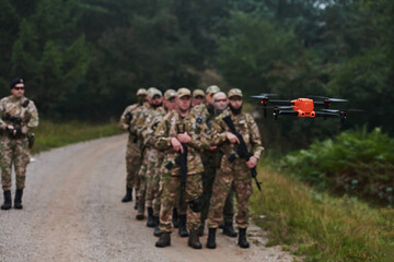 An elite military unit, led by a major, confidently parades through dense forest, showcasing...