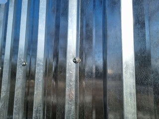 Reflection in a metal fence