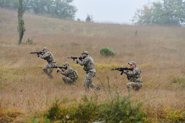 A disciplined and specialized military unit, donned in camouflage, strategically patrolling and...