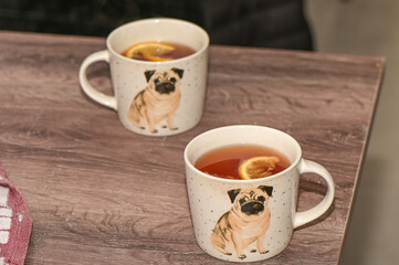tea with lemon in a cup with a drawn pug 4